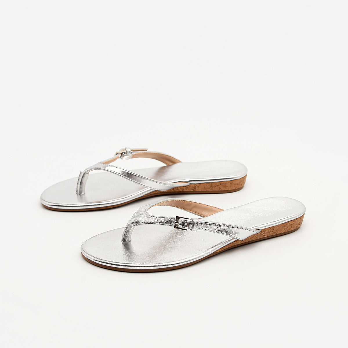 Mescini silver toe post low heel slide sandals, the pair angled on a white background, US women's sizes
