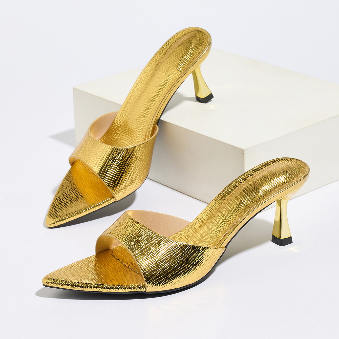 Mescini – Gold metallic pointed mules, angled studio pair on white, US women's sizes