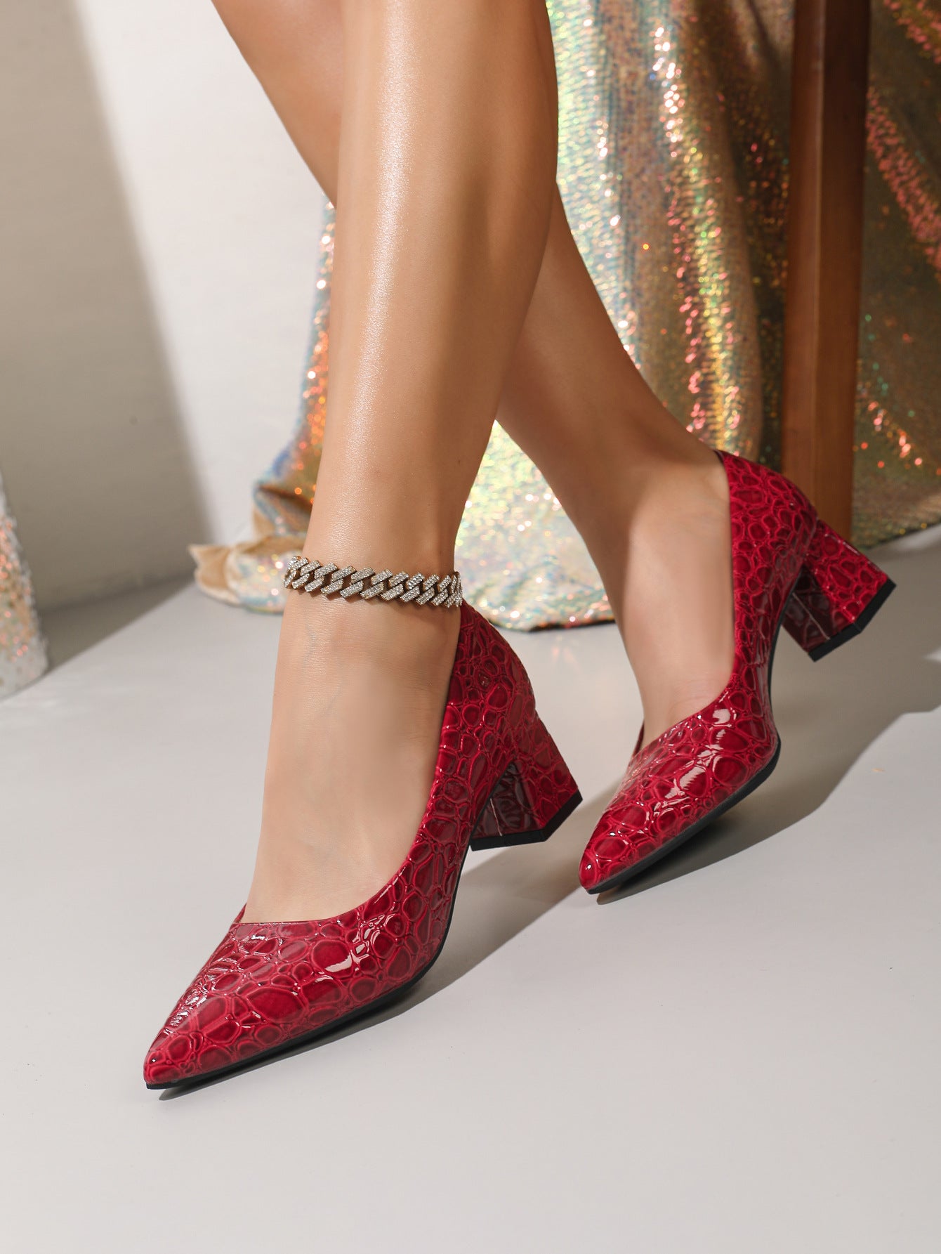 Mescini wine red croc embossed block heel pumps, worn by a model walking past silk, US women's sizes