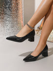 Mescini black croc embossed block heel pumps, worn by a model walking past silk, US women's sizes