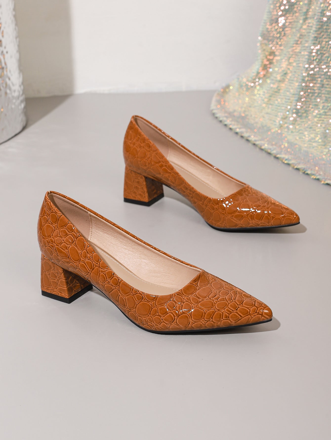 Mescini brown croc embossed block heel pumps, the pair set on a pale step, US women's sizes