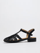 Mescini black woven closed toe block heel sandals, single shoe in profile on a white surface, US women's sizes