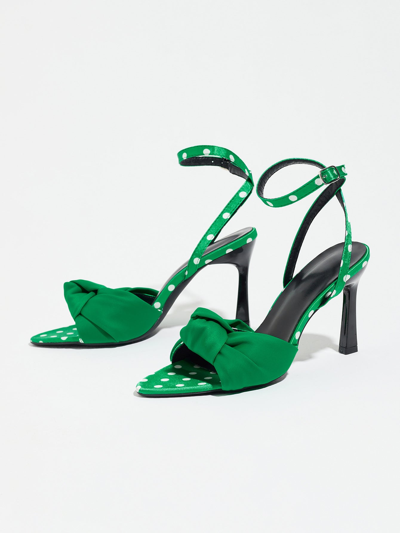 Mescini green knot front polka dot heeled sandals, pair photographed at a low angle, US women's sizes
