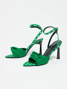 Mescini green knot front polka dot heeled sandals, pair photographed at a low angle, US women's sizes