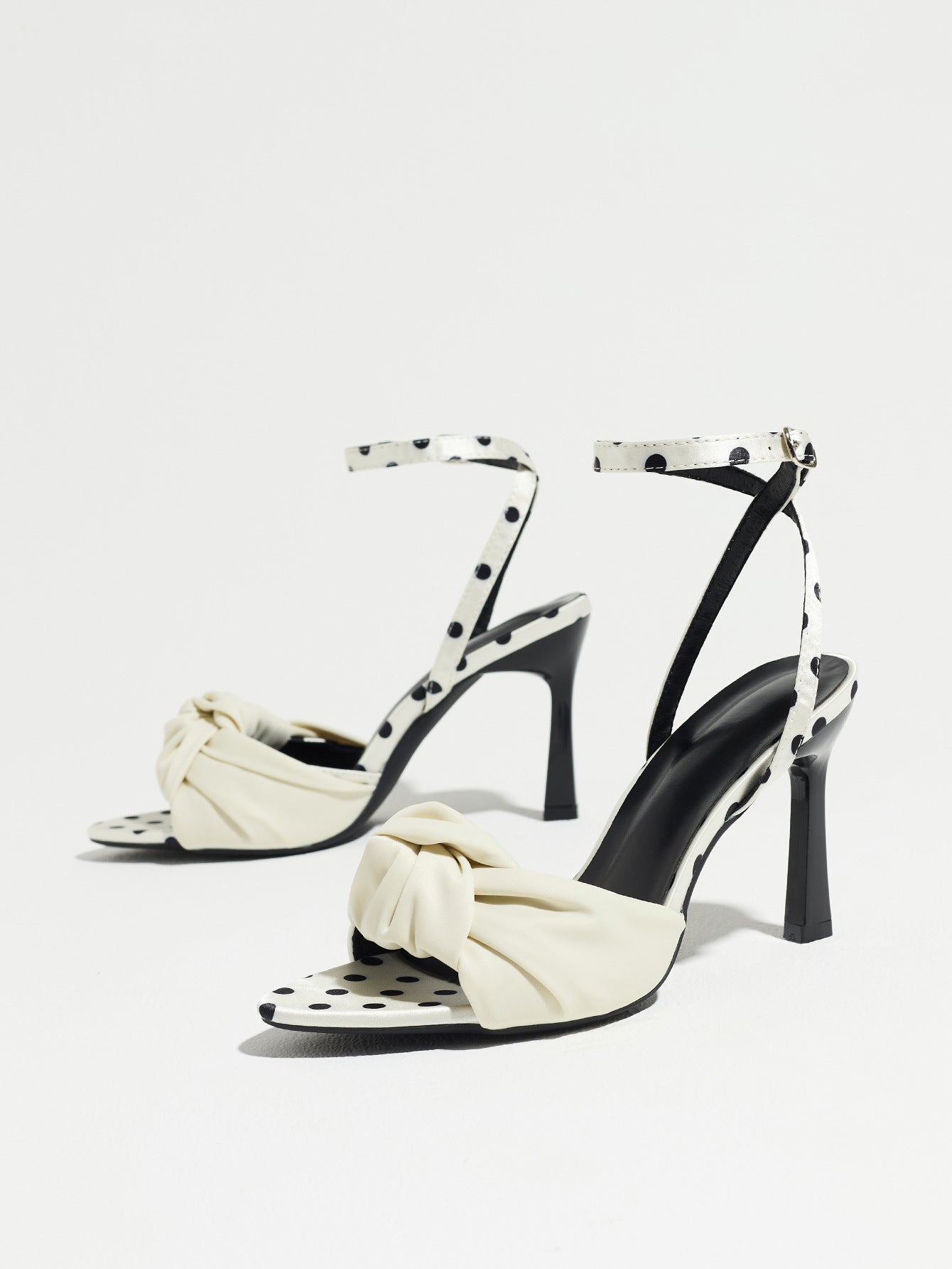 Mescini white knot front polka dot heeled sandals, pair angled against a plain backdrop, US women's sizes