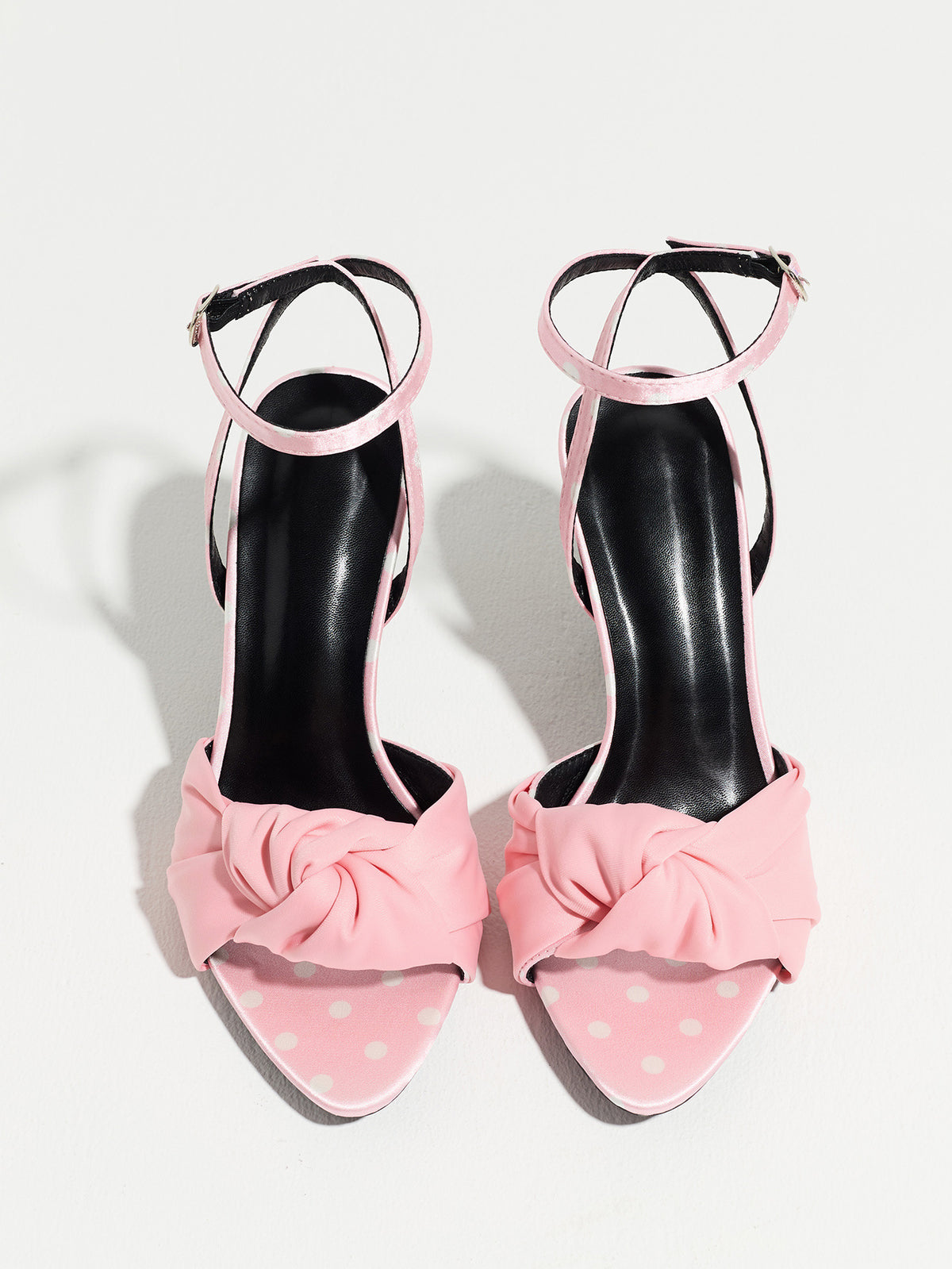Mescini pink knot front polka dot heeled sandals, pair seen from above on a white surface, US women's sizes