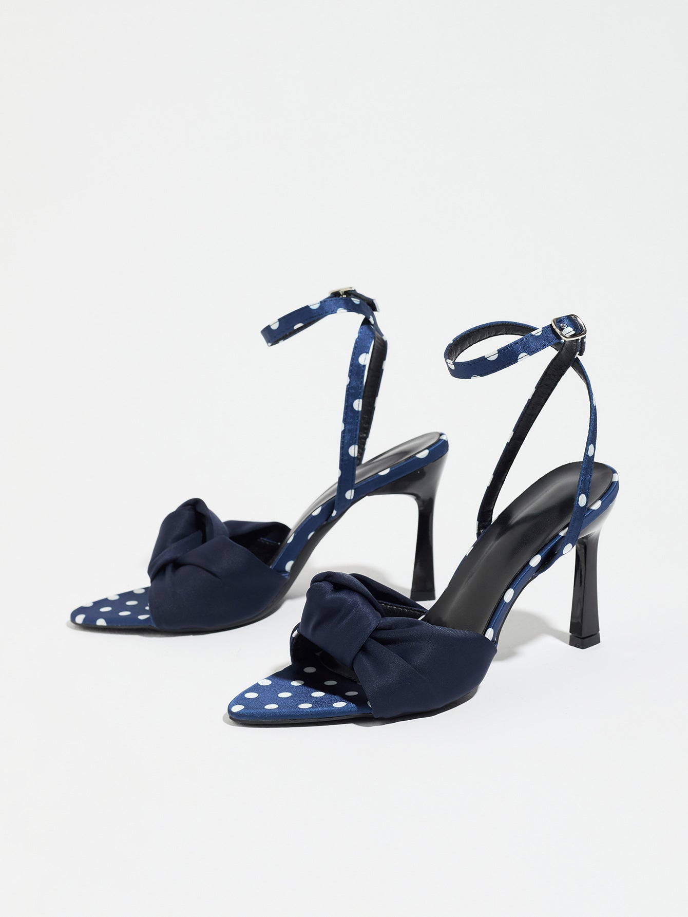 Mescini navy knot front polka dot heeled sandals, pair seen at an angle on white, US women's sizes