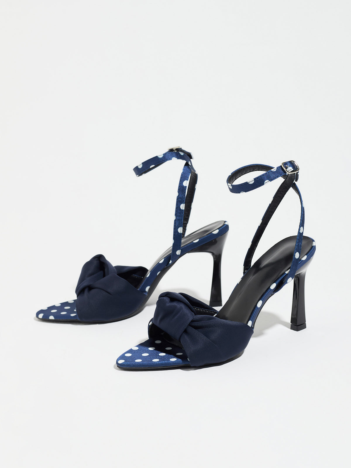 Mescini navy knot front polka dot heeled sandals, pair seen at an angle on white, US women's sizes