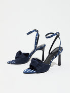 Mescini navy knot front polka dot heeled sandals, pair seen at an angle on white, US women's sizes