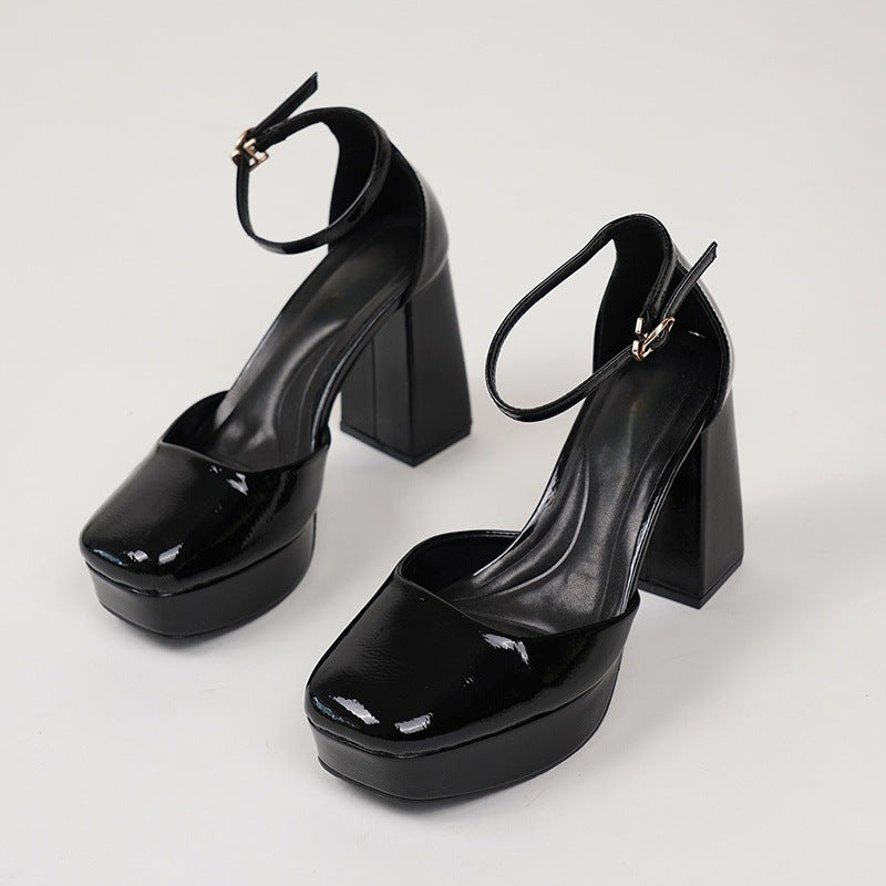 Mescini black patent platform ankle strap heels, the pair angled on a white studio floor, US women's sizes