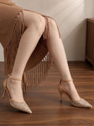 Mescini apricot embroidered mesh ankle strap pumps worn under a fringed skirt, US women's sizes