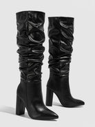 Mescini black slouchy knee high block heel boots, the pair standing on grey ground, US women's sizes