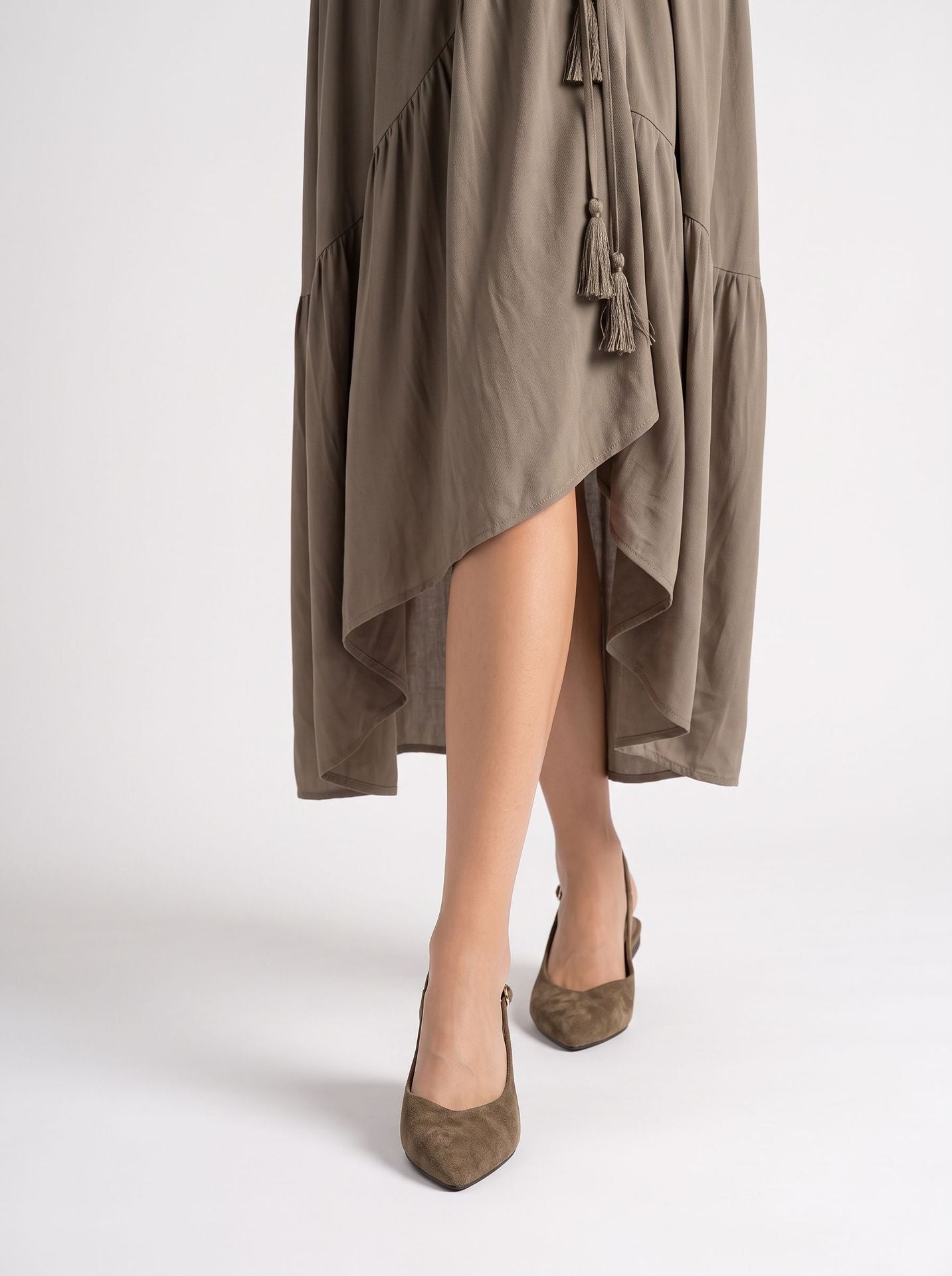 Mescini brown pointed toe slingback ballet flats, worn by a model seen from behind, US women's sizes