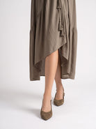 Mescini brown pointed toe slingback ballet flats, worn by a model seen from behind, US women's sizes