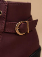 Close crop of the antique gold buckle strap on Mescini burgundy lace up ankle boots