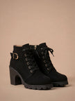 Mescini black lace up combat ankle boots with buckle strap and lug sole, angled pair view