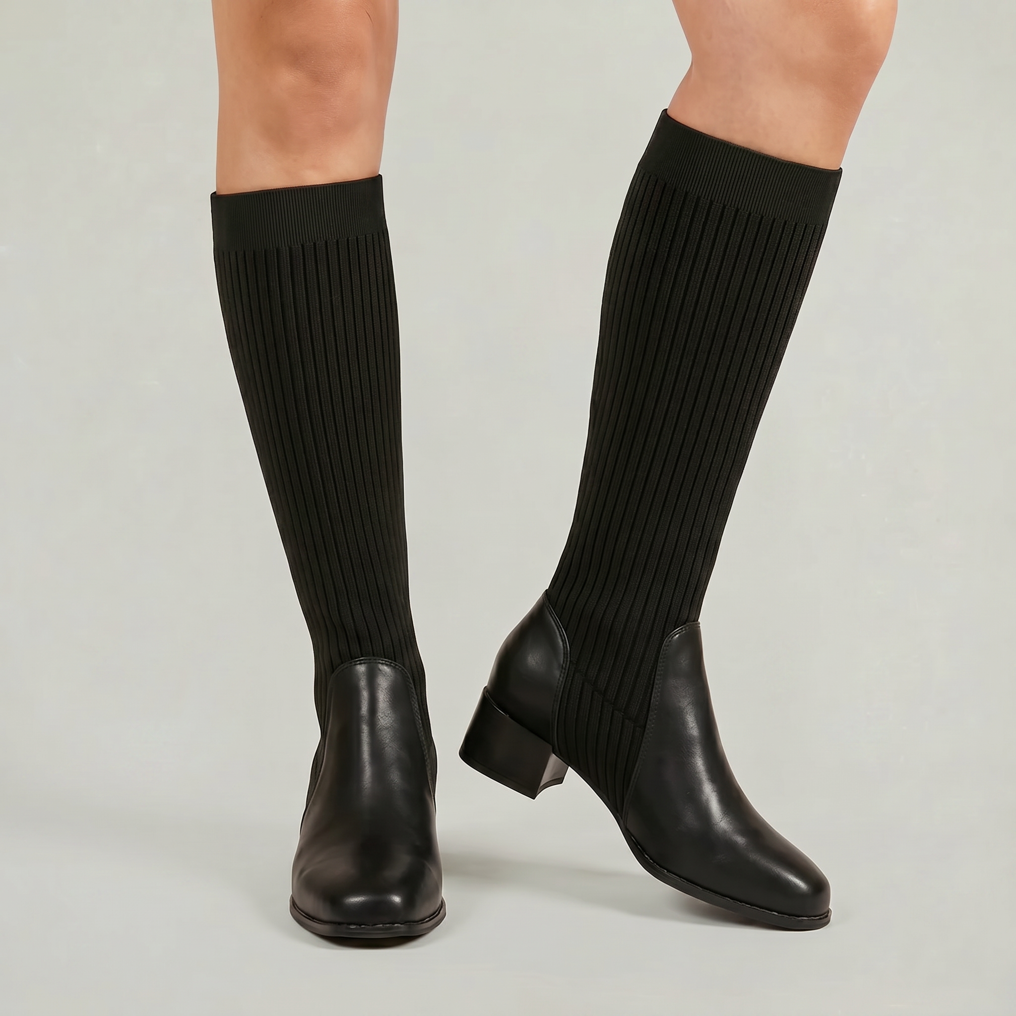 Mescini - black knit knee high boots on the model, front three quarter view, US women's sizes
