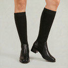 Mescini - black knit knee high boots on the model, front three quarter view, US women's sizes