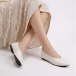 Mescini - off-white ballet flats worn seated, deep V vamp shown, US women's sizes