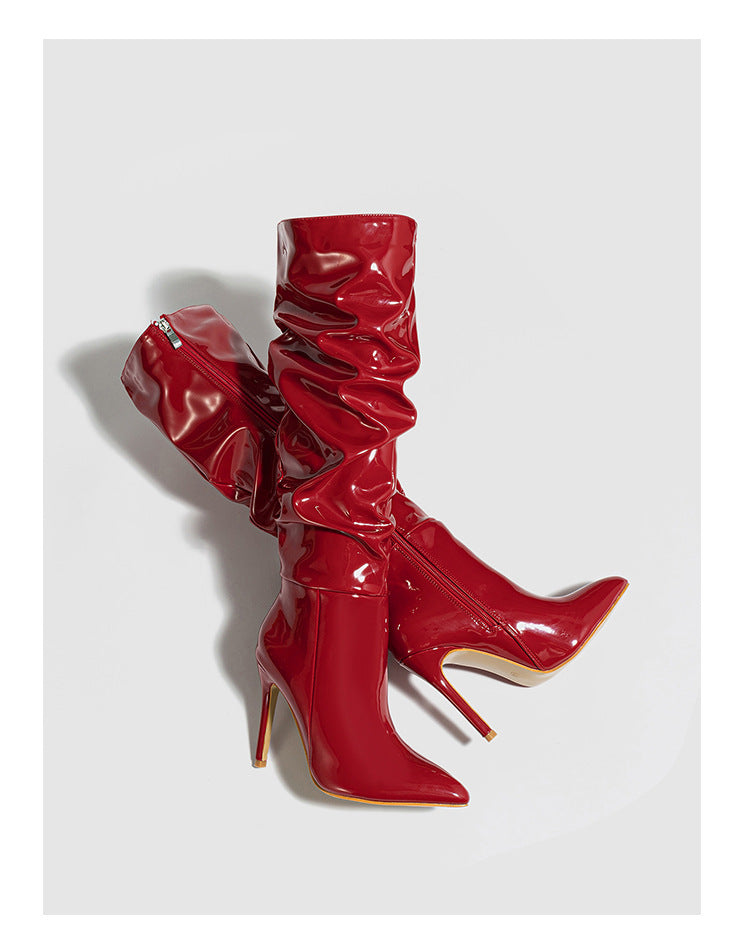 Mescini red ruched patent knee high stiletto boots, pair angled in the studio, US women's sizes