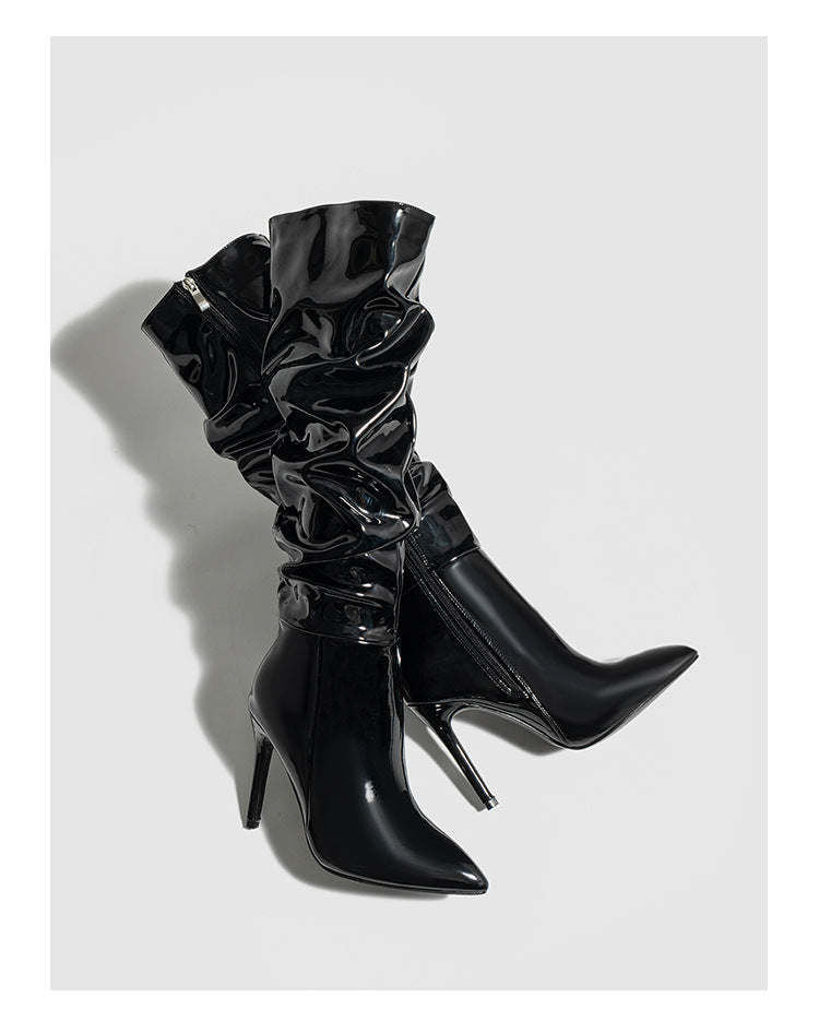 Mescini black ruched patent knee high stiletto boots, pair angled in the studio, US women's sizes