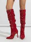 Mescini red ruched patent knee high stiletto boots, worn standing, seen from the front, US women's sizes
