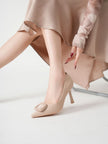 Mescini beige square ring pointed toe pumps worn on a chair, single shoe, US women's sizes