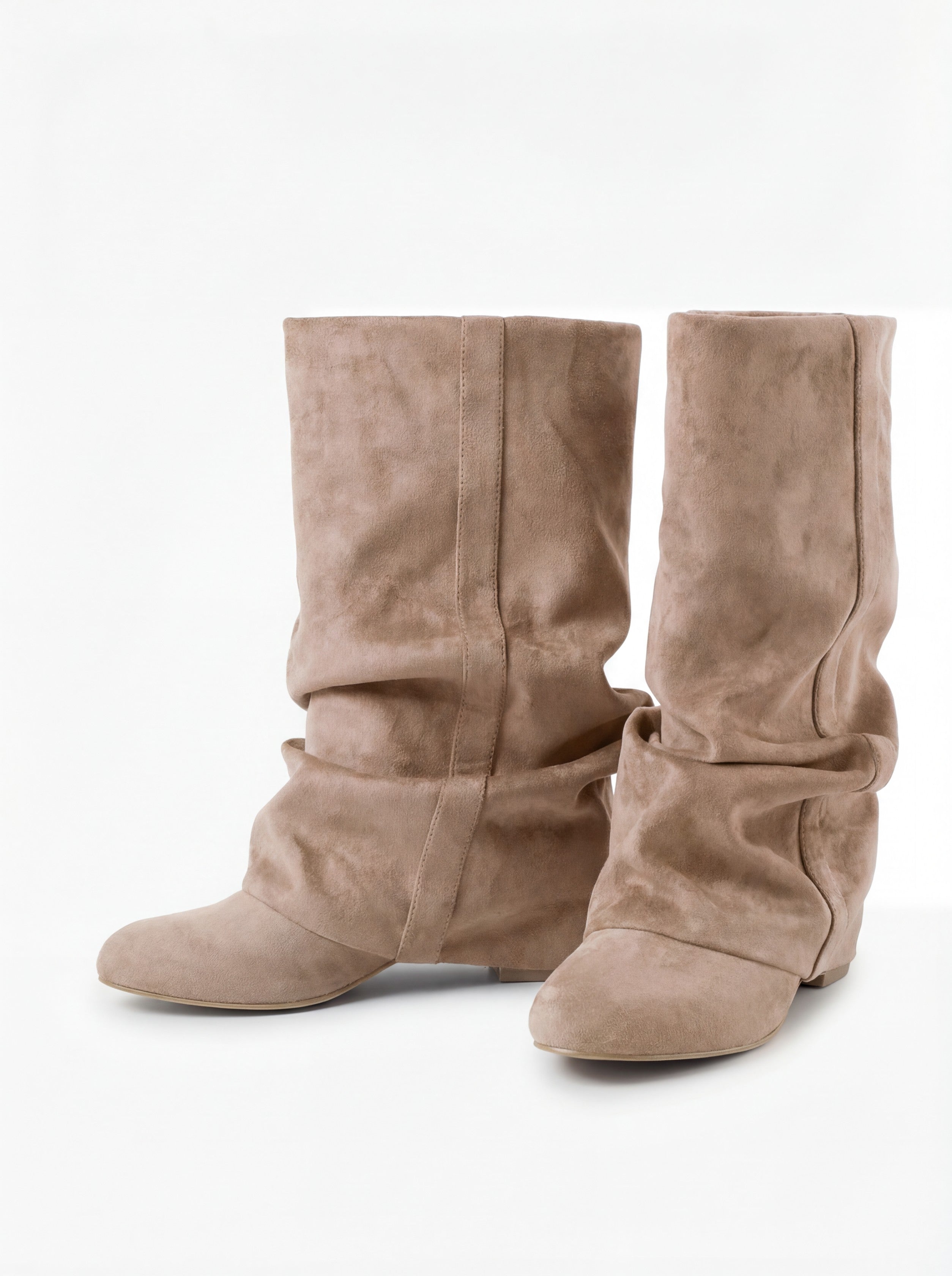 Mescini beige slouchy mid calf boots, worn by a model seated on a bench, US sizes