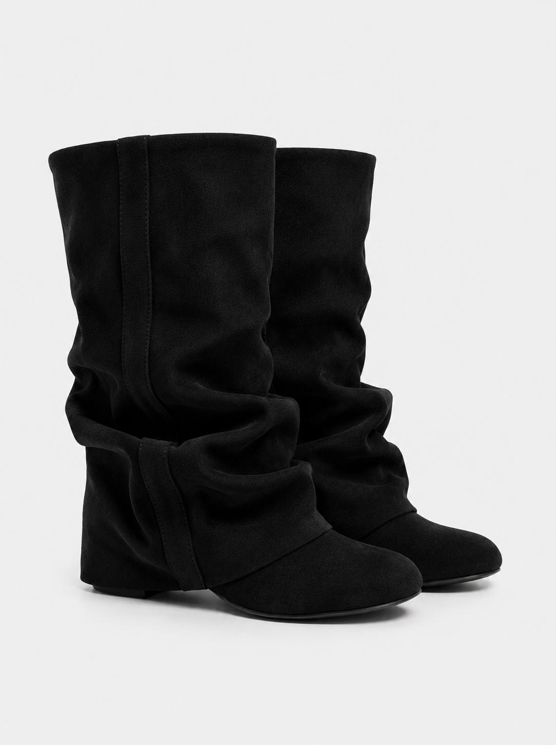 Mescini black slouchy mid calf boots, worn by a model seated on a bench, US sizes