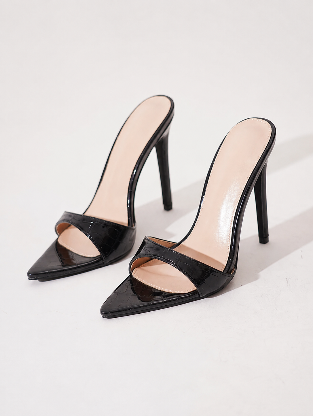 Mescini black croc embossed pointed stiletto mules, the pair angled on a pale grey backdrop, US women's sizes