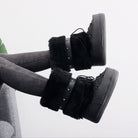 Mescini - black faux fur snow boots worn with grey jeans, lifestyle shot, US women's sizes