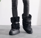 Mescini black faux fur studded platform snow boots, worn standing with grey jeans, US women's sizes
