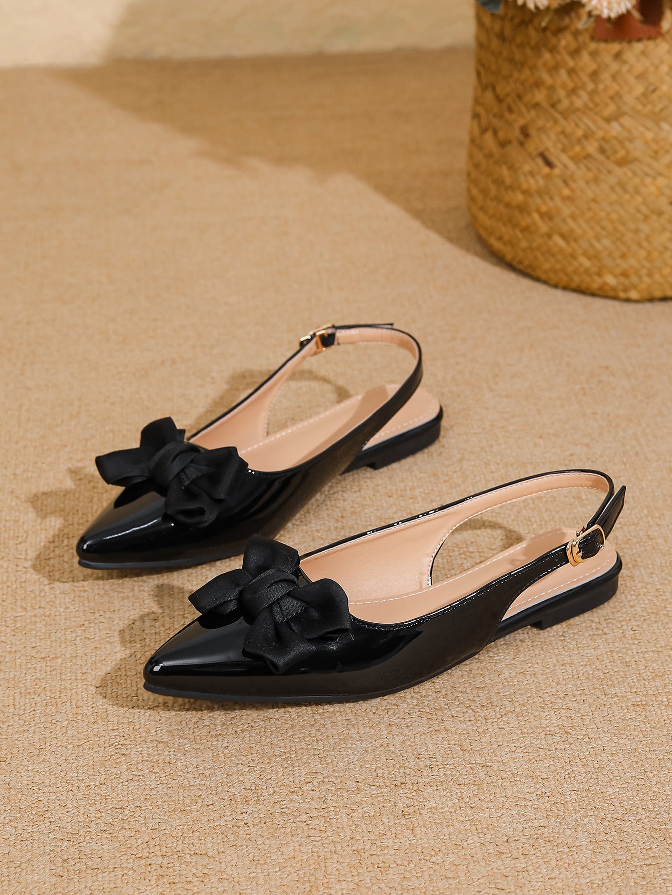 Mescini black bow pointed toe slingback flats, pair resting on a beige woven mat, US women's sizes