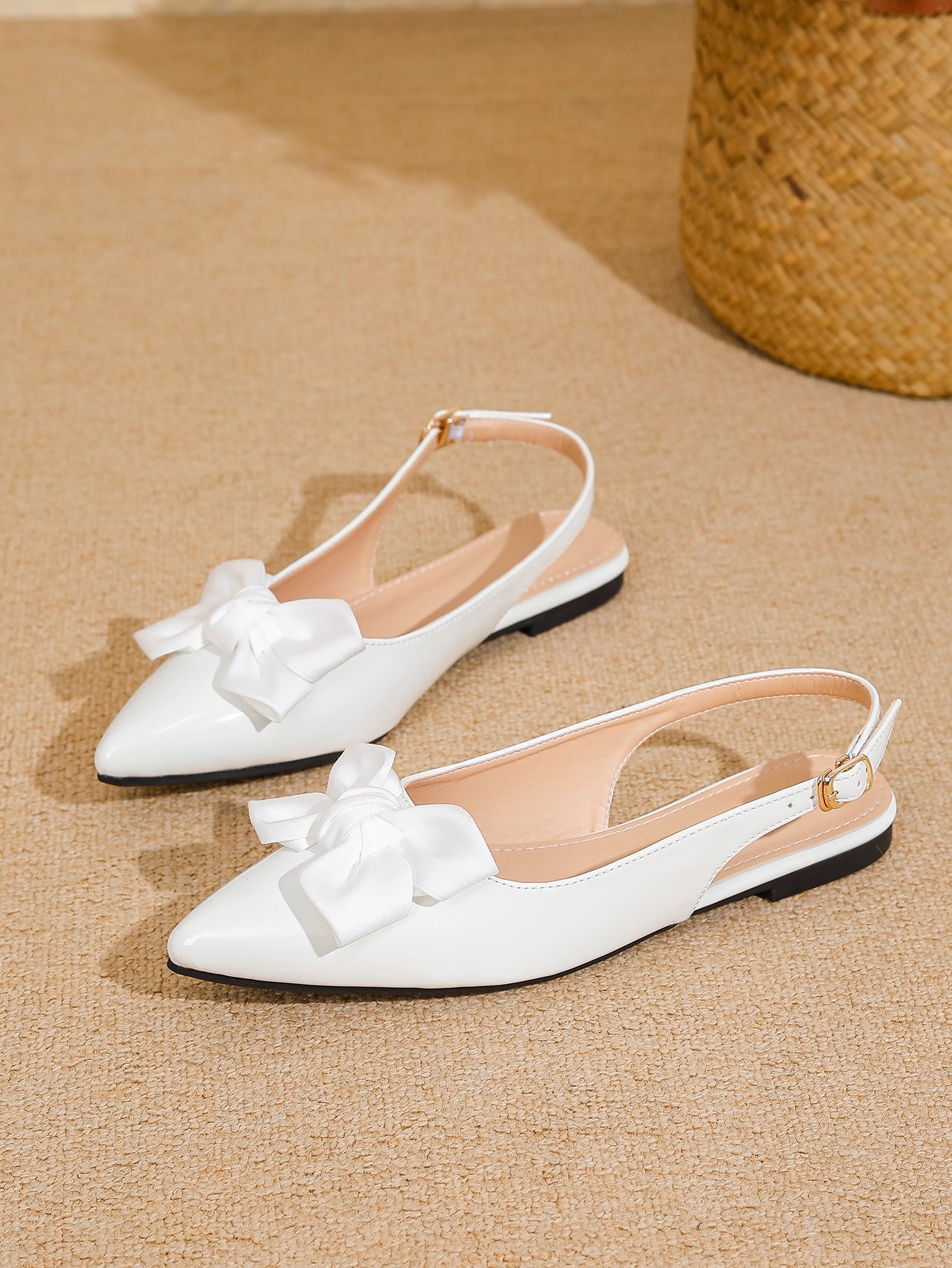 Mescini white bow pointed toe slingback flats, pair set on a woven beige surface, US women's sizes