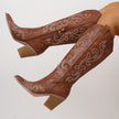 Mescini brown western cowboy boots worn with legs raised, embroidered shafts in view