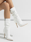 Mescini white slouchy patent mid calf boots, worn on a model seen from the side, US women's sizes