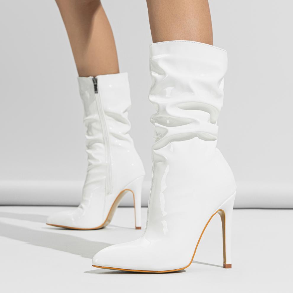 Mescini white slouchy patent mid calf boots, worn on a model with both feet forward, US women's sizes