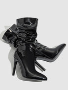 Mescini black slouchy patent mid calf boots, the pair lying down on a grey backdrop, US women's sizes