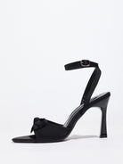Mescini black satin bow ankle strap sandals, single shoe seen from the side, US women's sizes