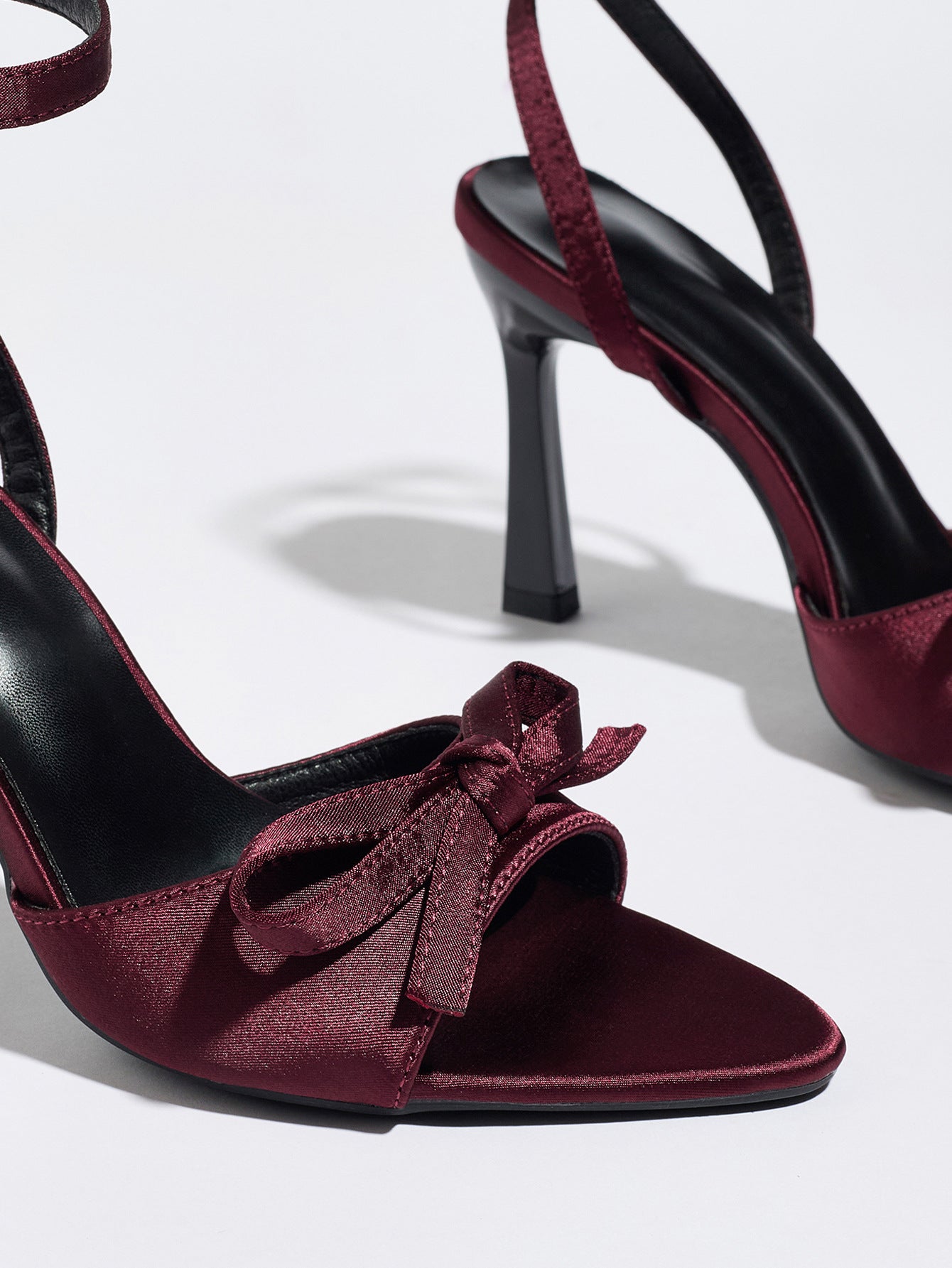 Mescini burgundy satin bow ankle strap sandals, close up of the knot at the pointed toe, US women's sizes