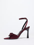 Mescini burgundy satin bow ankle strap sandals, single shoe photographed from the side, US women's sizes