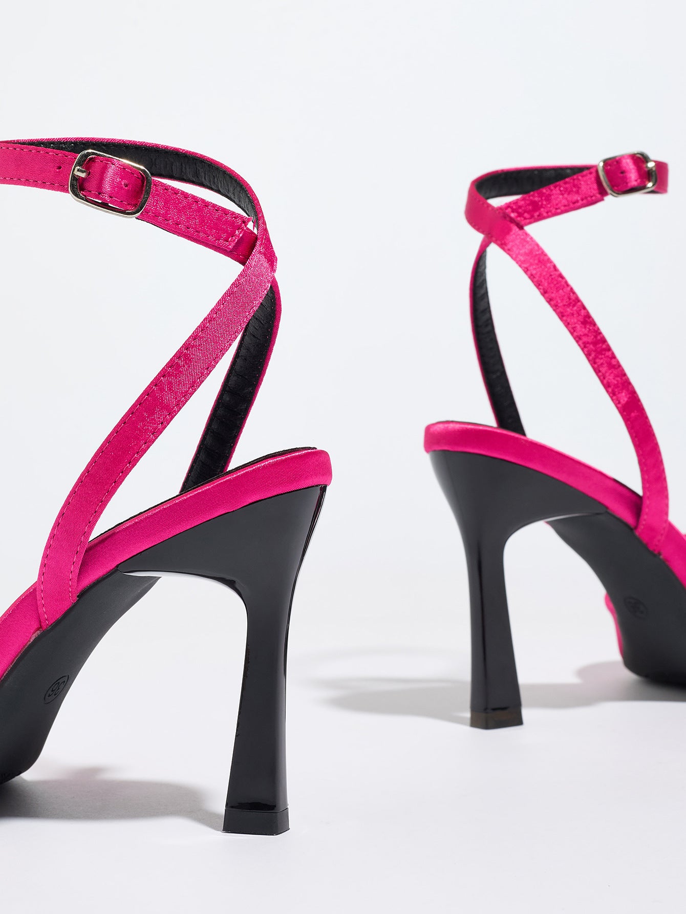 Mescini pink satin bow ankle strap sandals, rear view of the pair on a white studio floor, US women's sizes