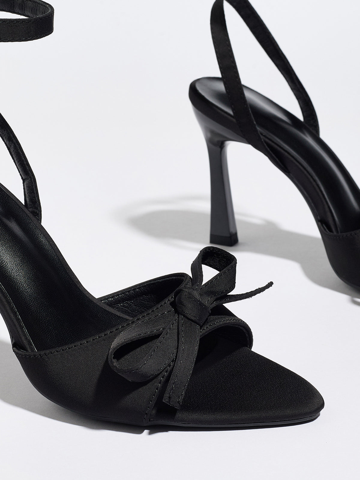 Mescini black satin bow ankle strap sandals, close up of the knotted trim and toe, US women's sizes