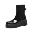 Mescini black glossy platform chelsea rain boots, single shoe on a plain ground, US women's sizes