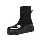 Mescini black glossy platform chelsea rain boots, single shoe on a plain ground, US women's sizes