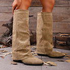 Mescini khaki fold over knee high boots worn standing, hand at the cuff, US women's sizes