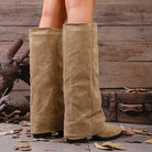 Mescini khaki fold over knee high boots worn front on against a wooden wall, US women's sizes