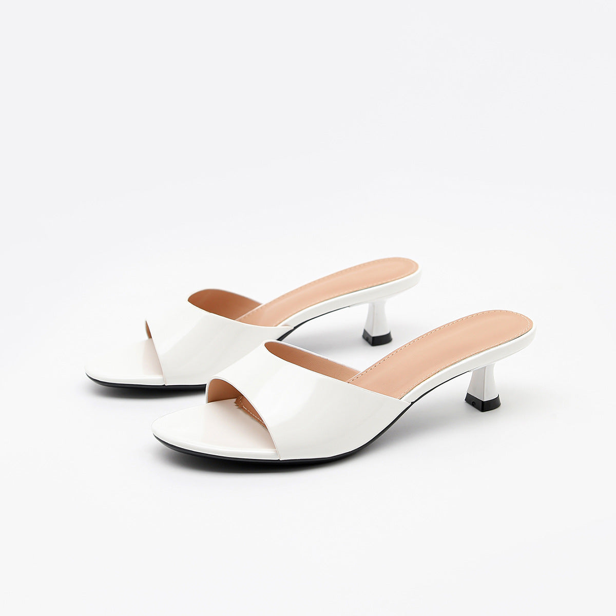 Mescini – White patent square toe slide mules, angled studio pair, US women's sizes