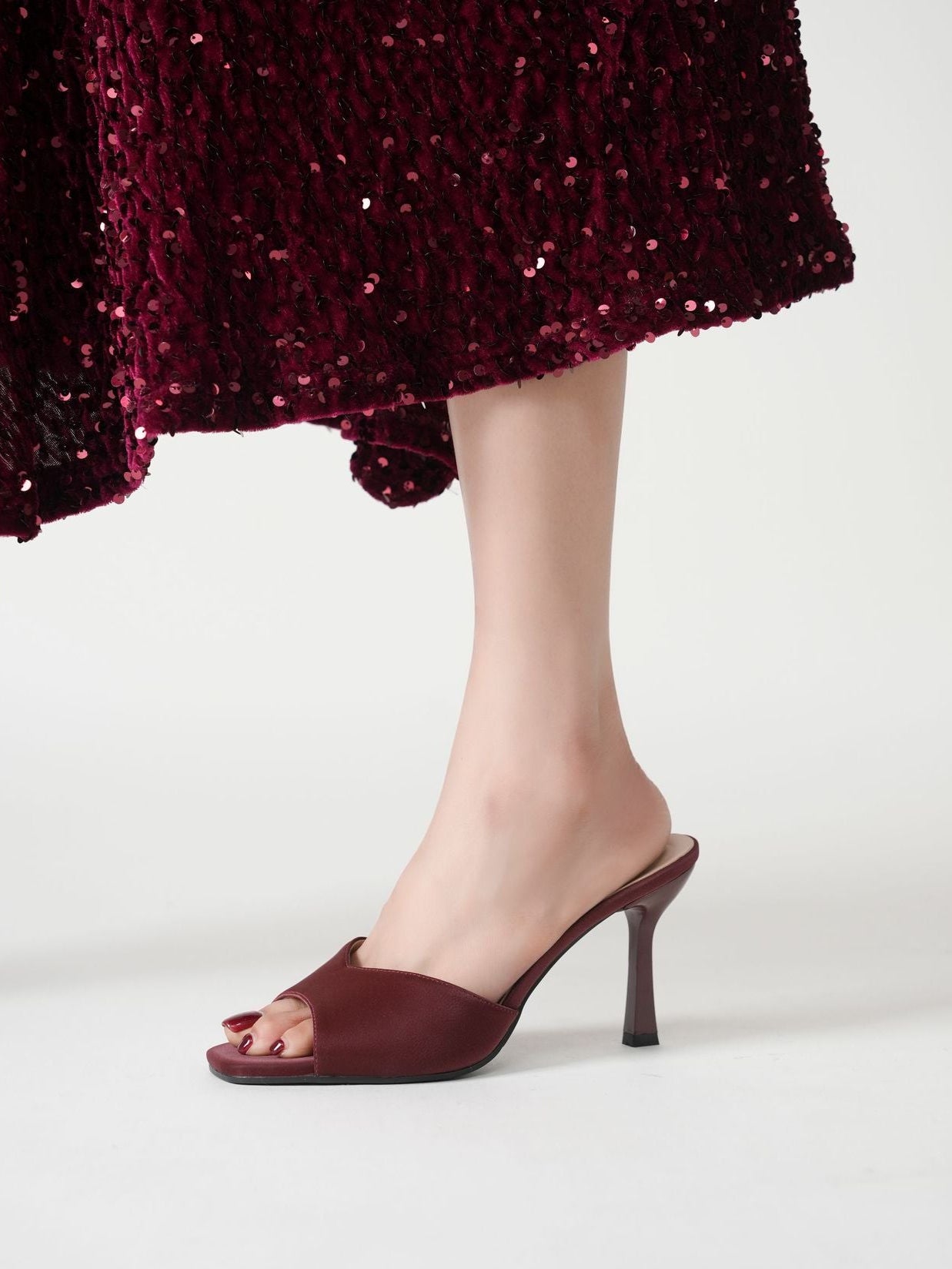 Mescini burgundy wide band square toe mule, single shoe worn mid stride, US women's sizes