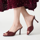 Mescini – burgundy square toe stiletto mules worn with a sequin skirt, US women's sizes